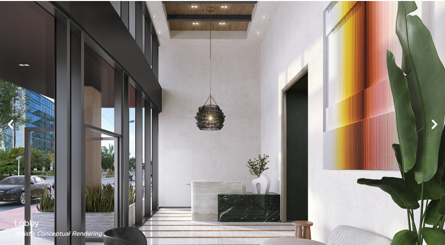 District 225 lobby — double-height ceilings, designer furnishings, concierge desk