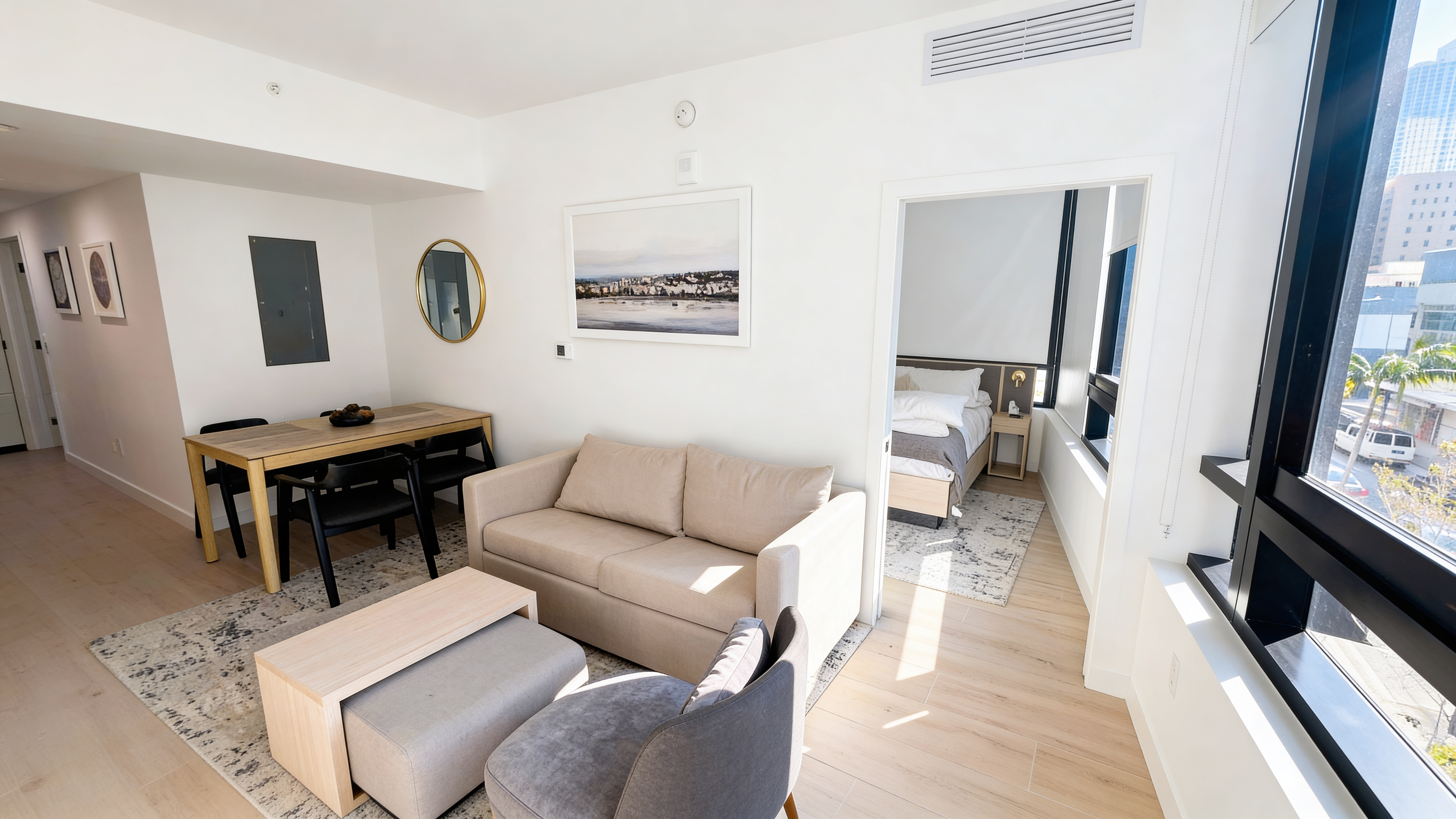 Open living and dining area — Meshberg Design furnishings, floor-to-ceiling windows with city light